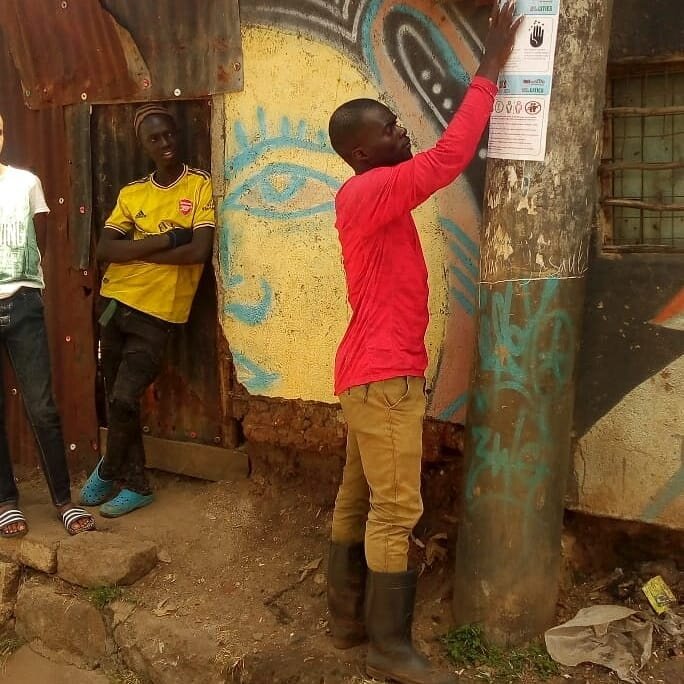 Youth-in-Korogocho-informal-settlement-Nairobi-put-up-public-health-posters-in-their-neighbourhood.-Photo-Muungano-KYC.TV_