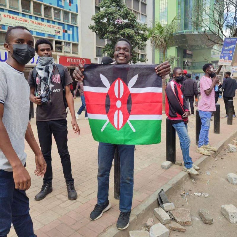 Young person holding a Kenyan flag