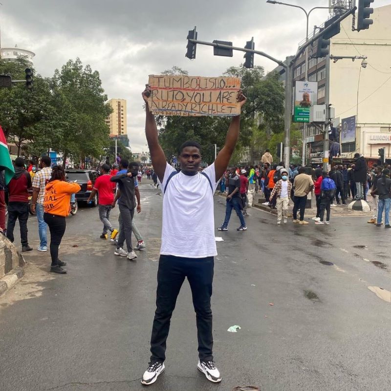 Young person holding a protest banner