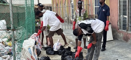 Community members sort waste into sacks